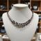 Handcrafted black and white Kumihimo necklace by Bead & Braid Collective displayed in boutique setting with spiral bead and braid accents